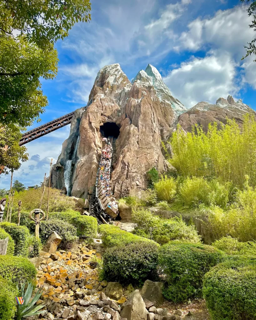 A train coming down the 80 foot drop out of the mountain on Expedition Everest.