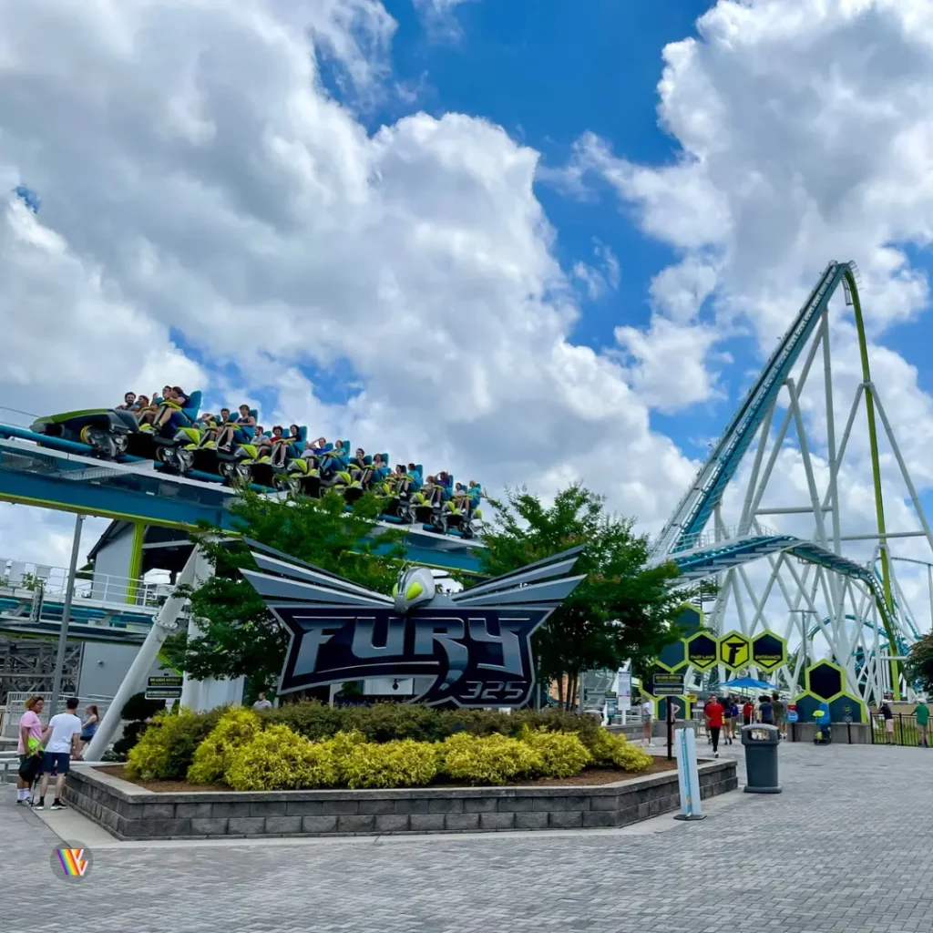 Fury 325 roller coaster entrance with train on brakes over entrance sign and large lift hill in background at Carowinds