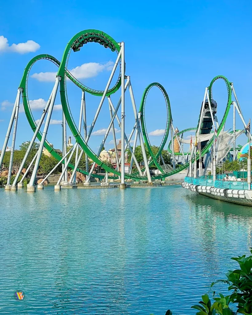 Incredible Hulk, one of the fastest roller coasters in Florida, going through its cobra roll as seen from across the lake at Universal Islands of Adventure