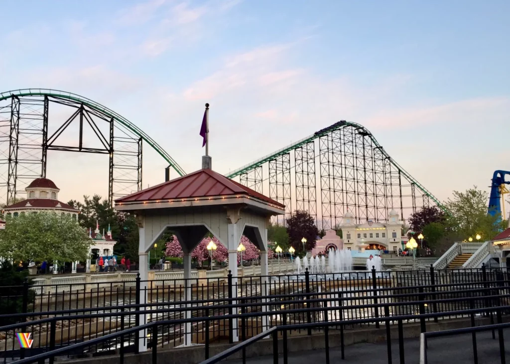 Looking at Phantom's Revenge roller coaster in Lost Kennywood near Pittsburg Plunge as sun sets at Kennywood Park