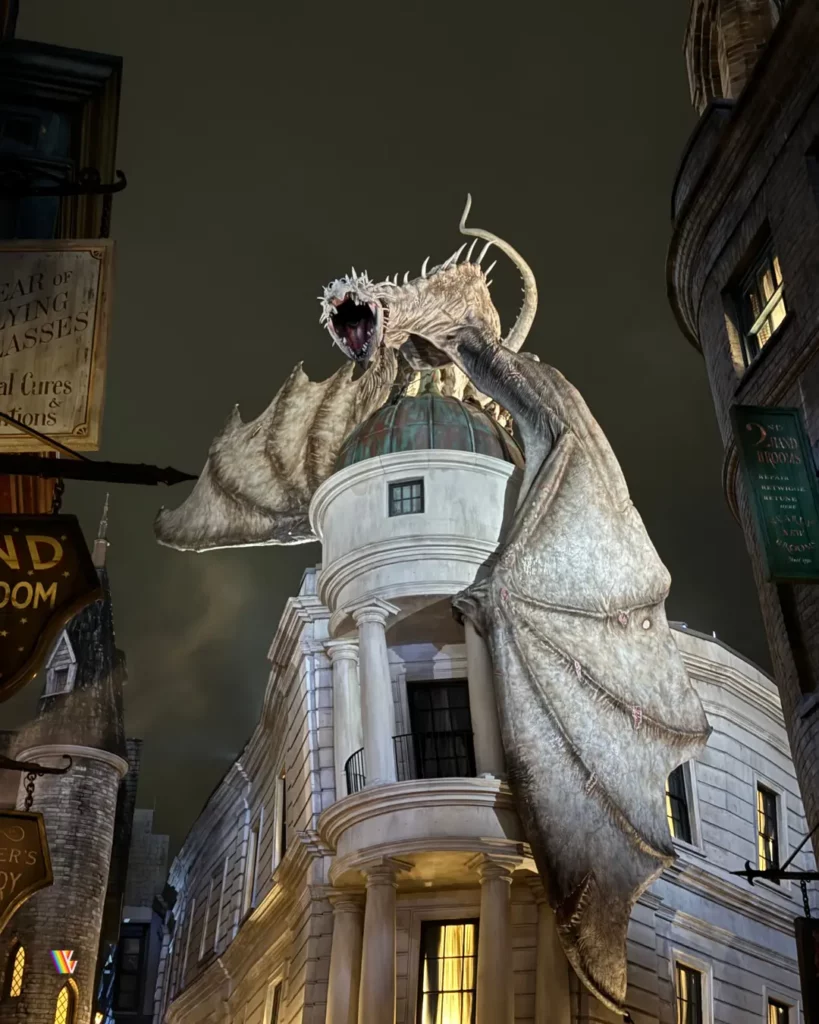 Looking up at dragon on top of Escape From Gringotts at Universal Studios Florida at night