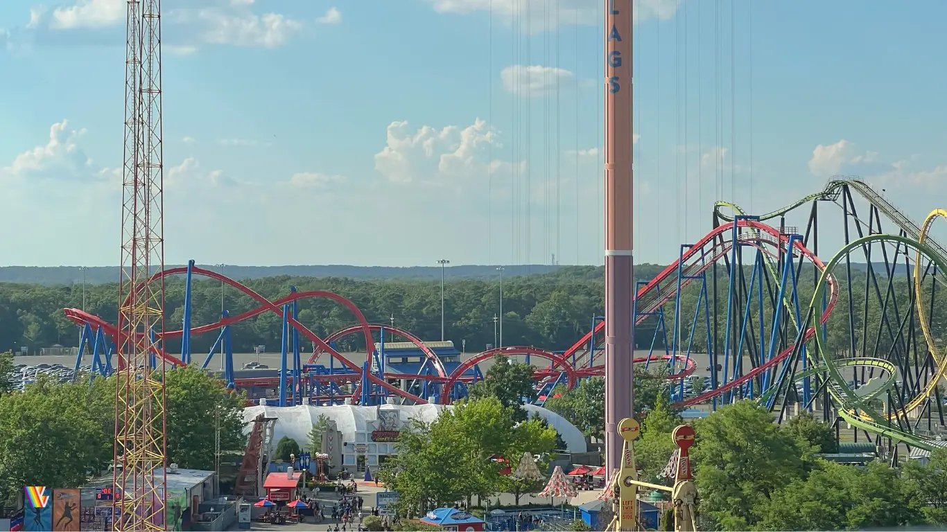 From the skyride, looking at Superman Ultimate Flight and Green Lantern roller coasters down boardwalk area at Six Flags Great Adventure. Parachute Drop and Slingshot are in foreground.