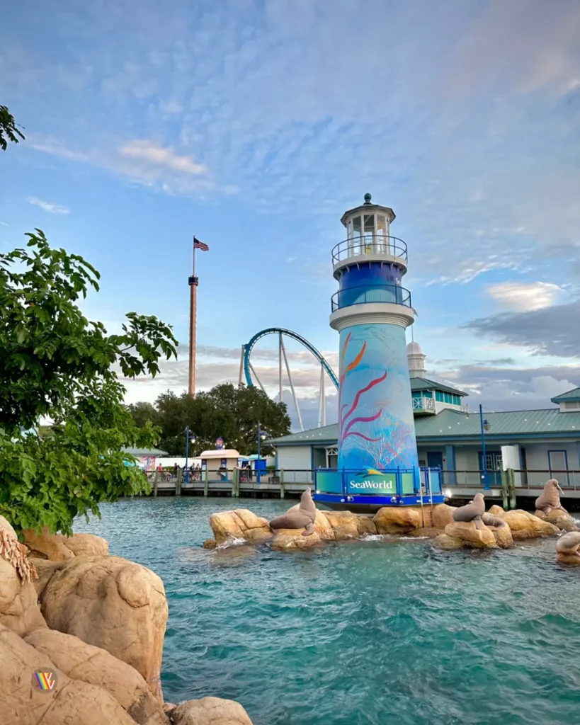 Lighthouse with Pipeline roller coaster and observation tower behind it at SeaWorld Orlando